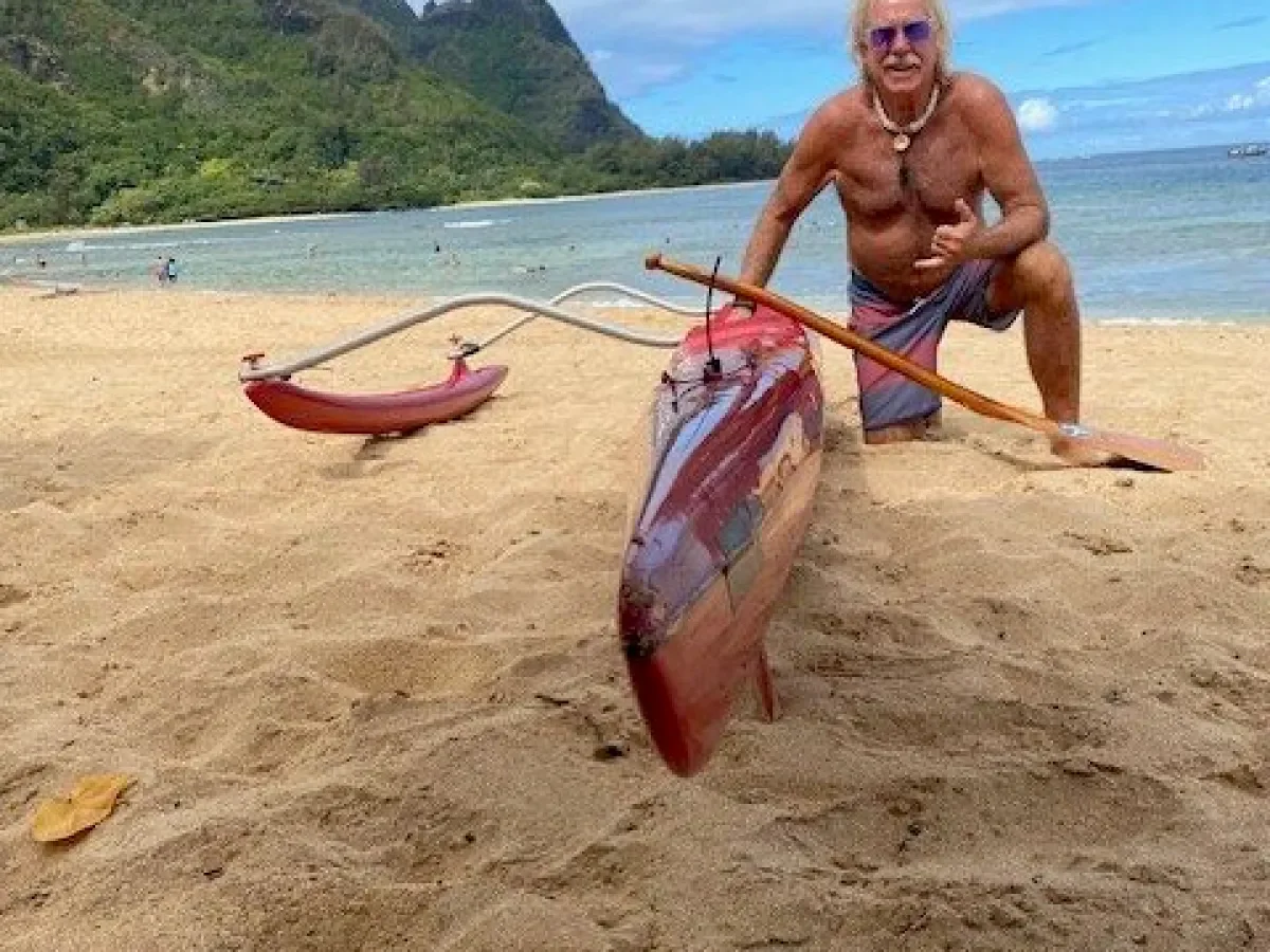 Mike Dennis with his outrigger canoe on the beach
