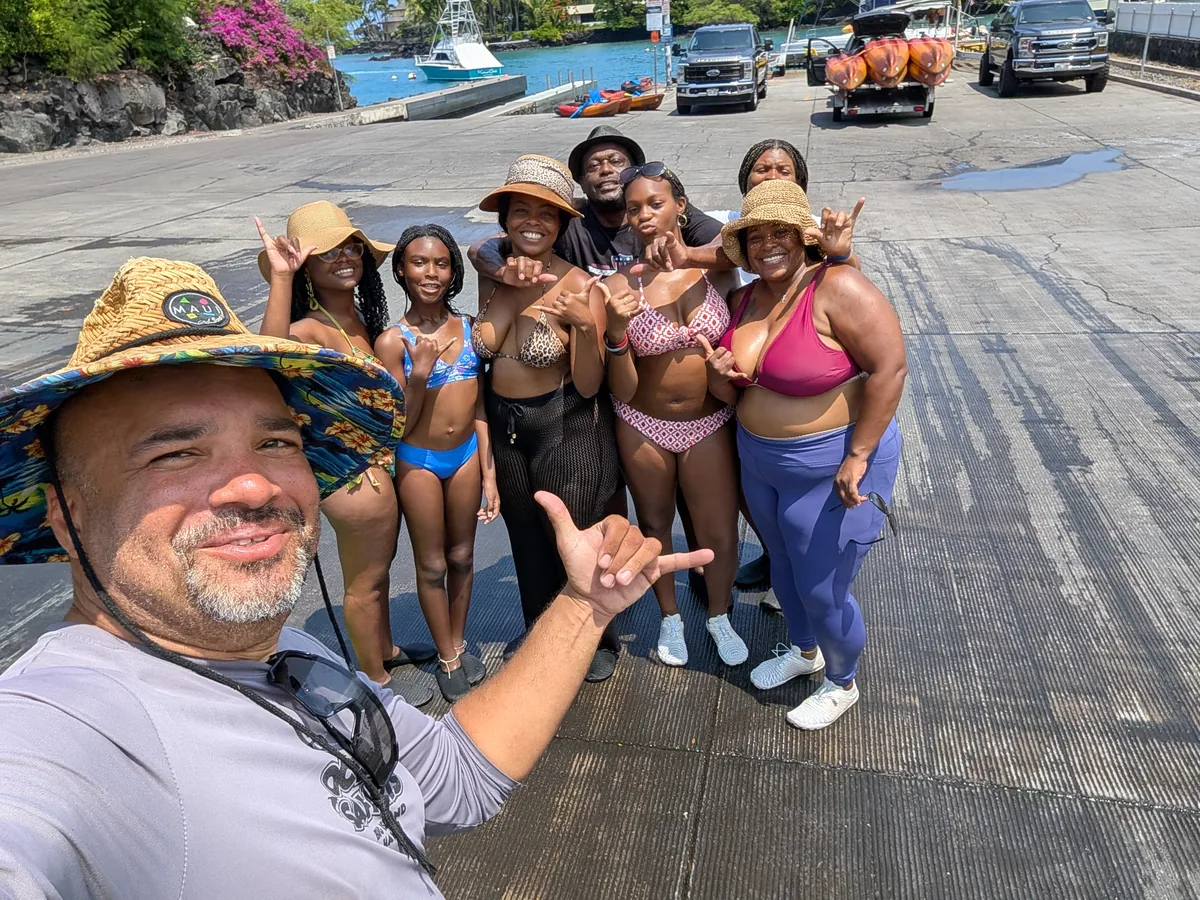 Winfield throwing a shaka with a big, happy group of guests at the Keauhou Bay boat ramp