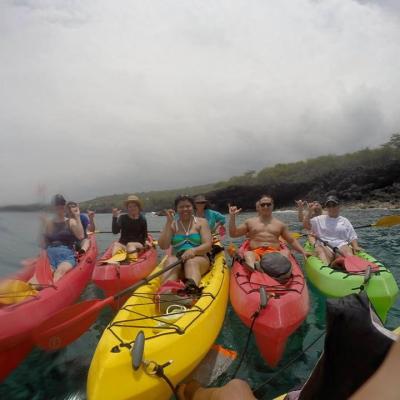 a group of people in a boat on a body of water